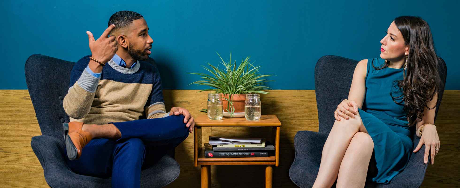 two business partners sitting in separate chairs in disagreement
