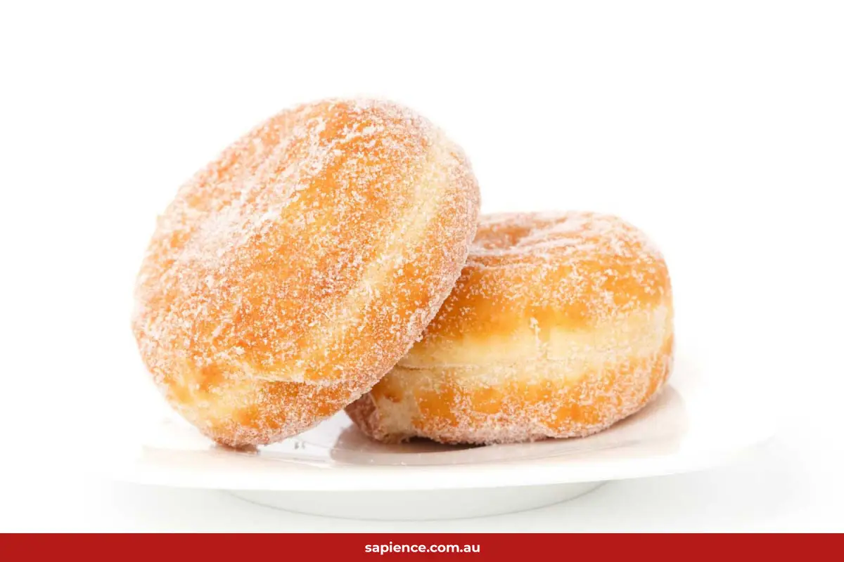 two identical jam donuts on a plate