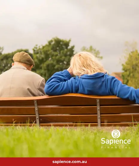 elderly man sitting on park bench with daughter