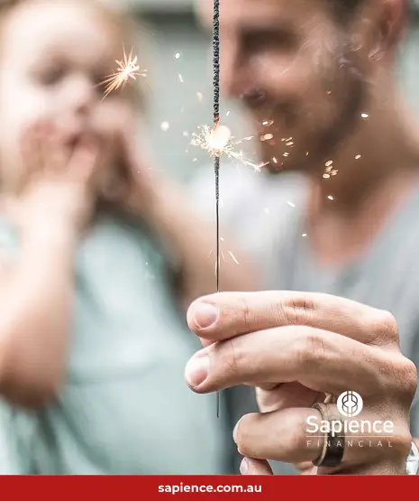 father holding sparkler and his young daughter