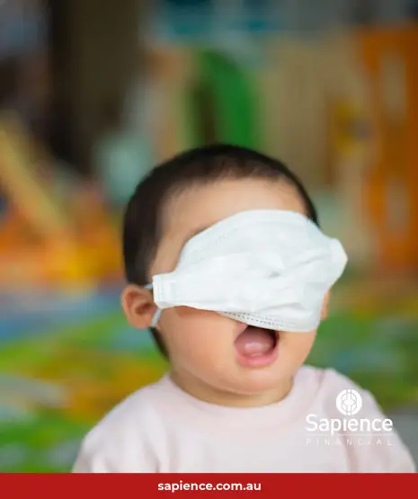 happy young toddler with white face mask over his eyes