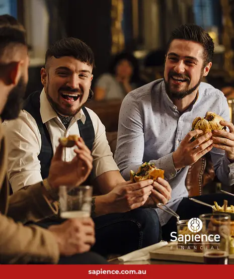 Three business friends eating a meal and laughing