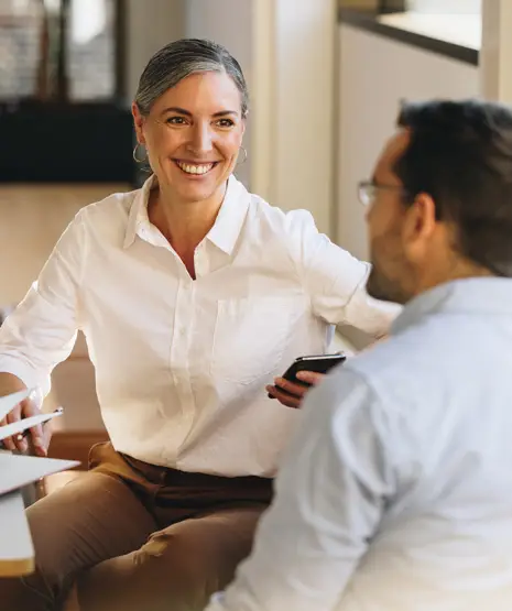 smiling female and male business partners in comfortable  conversation