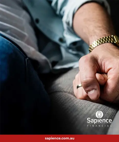 couple holding hands on sofa