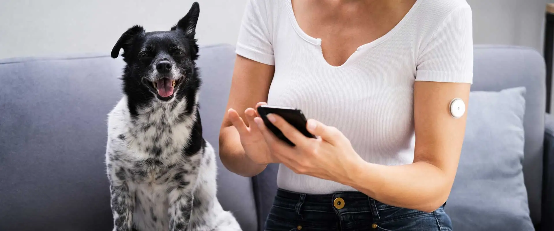 Women with her dog and continuous glucose monitoring sensor on her arm