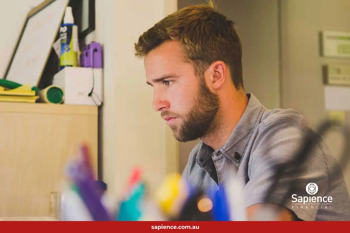 young creative man looking at computer monitor
