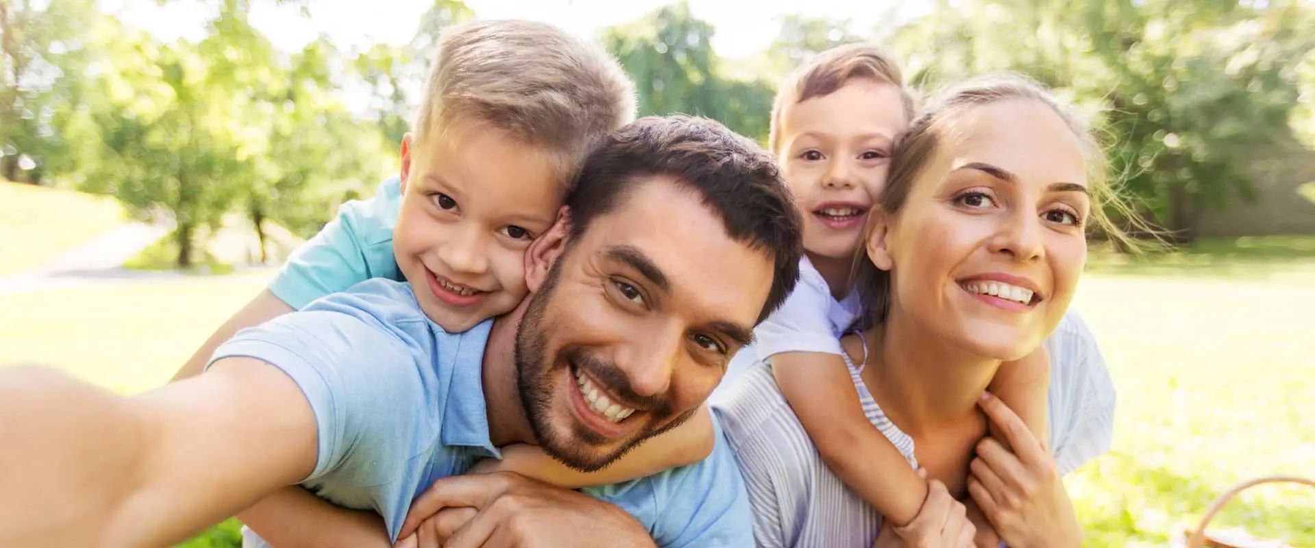 affectionate young family with two children playing in the park