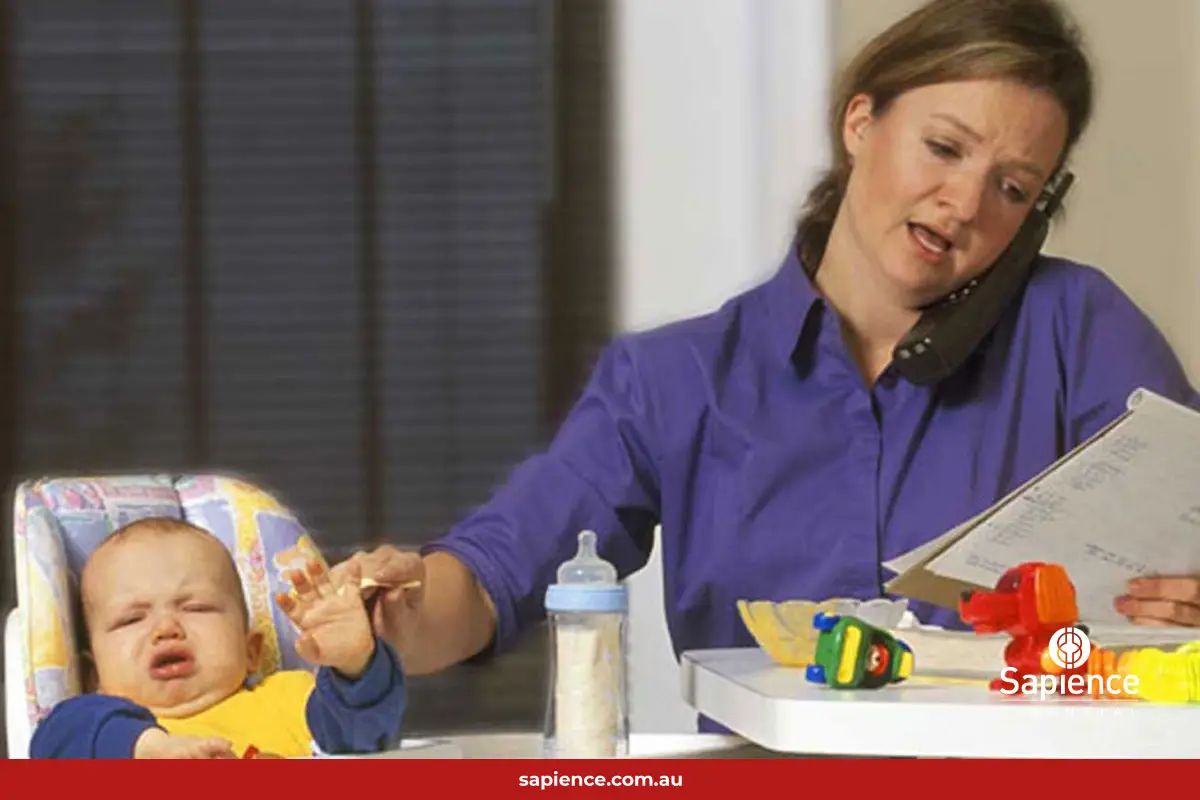 busy business woman on phone and feeding her baby at the same time