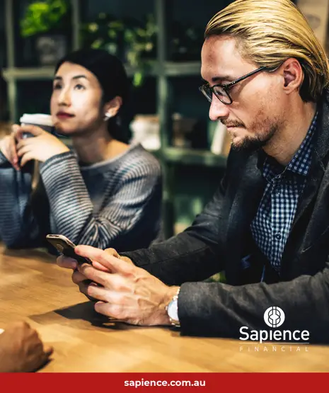 a modern businessman checks his mobile device over coffee
