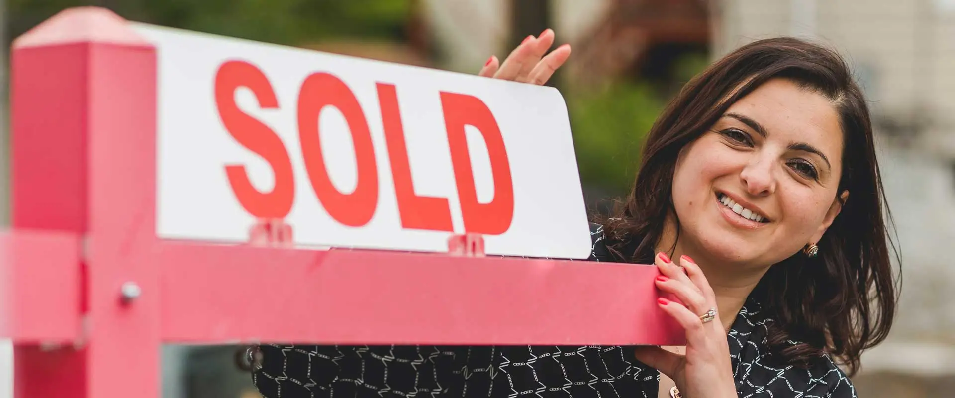 property with sold sign and new owner