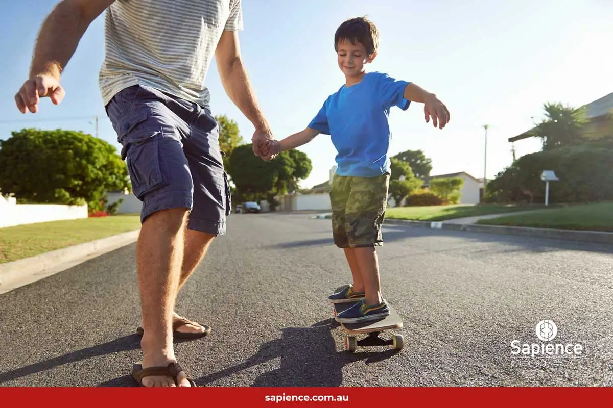 child learning to ride skateboard