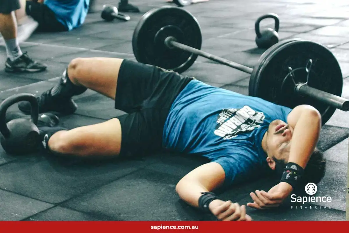 man laying on floor in a gym